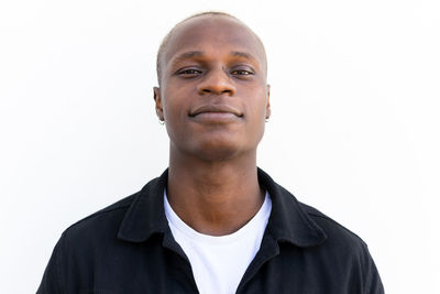 Portrait of young man against white background