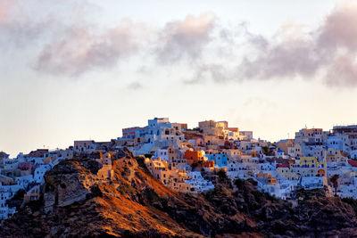 Santorini against sky during sunset