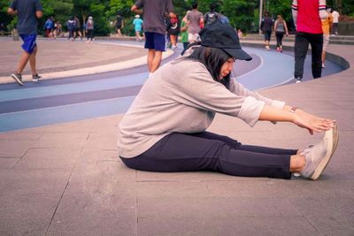 Rear view of people walking on street