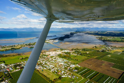 Aerial view of sea seen through airplane window