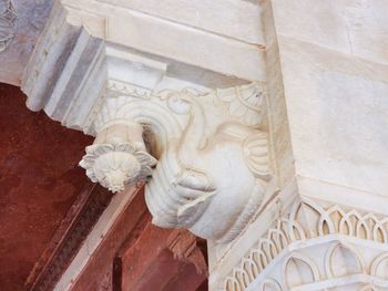 Low angle view of statue against historic building