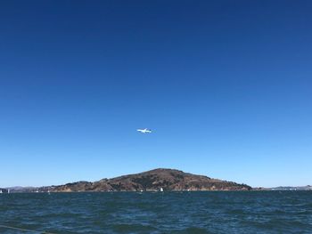 Scenic view of sea against clear blue sky