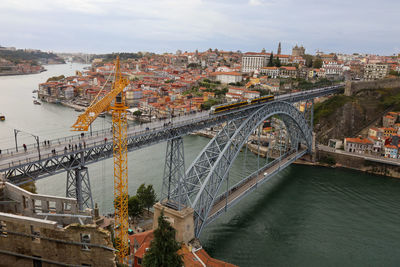 High angle view of bridge over river in city against sky