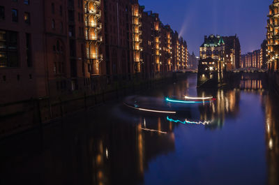 Boats in river with buildings in background