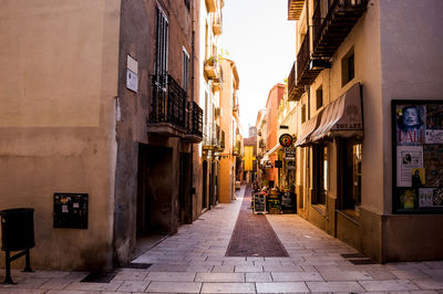 Narrow street amidst buildings in city