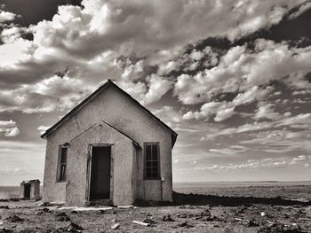 House on beach by sea against sky