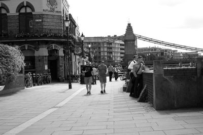People walking on bridge in city