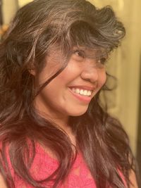 Close-up portrait of a smiling young woman