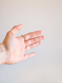 Close-up of woman hand over white background