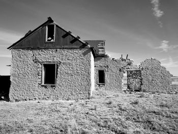 Exterior of abandoned house against sky