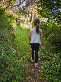 Full length rear view of woman walking on land