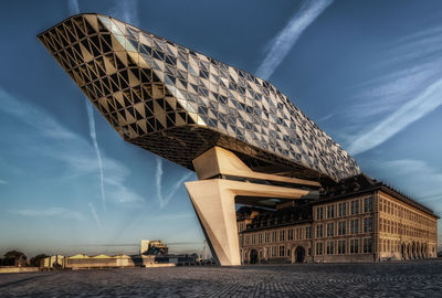 Low angle view of modern building against blue sky