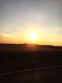 Scenic view of field against sky during sunset