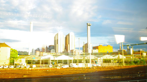 Skyscrapers against cloudy sky