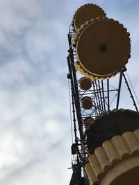 Low angle view of communications tower against sky