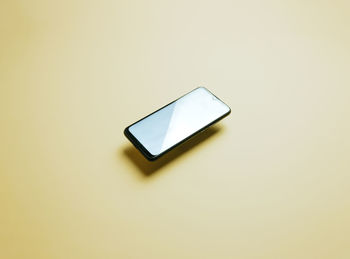 Close-up of mobile phone against white background