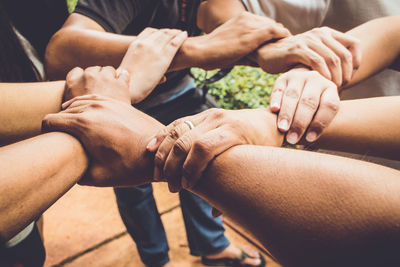 Midsection of couple holding hands