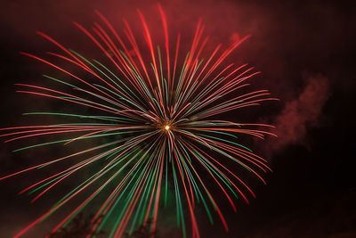 Low angle view of firework display at night