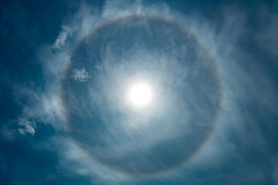 Low angle view of bright sun in sky