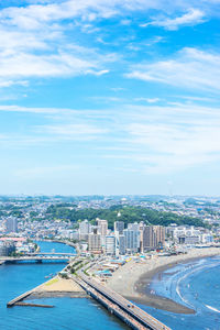 High angle view of cityscape by sea against sky