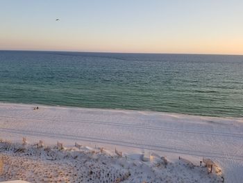 Scenic view of sea against clear sky during sunset