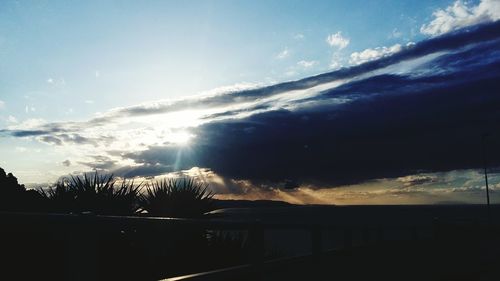 Scenic view of silhouette mountains against sky at sunset