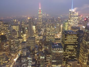 Aerial view of illuminated buildings in city at night