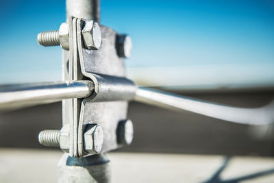 Close-up of metal railing against sky