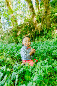 Closeup portrait of a baby boy smiling outdoors at a local park