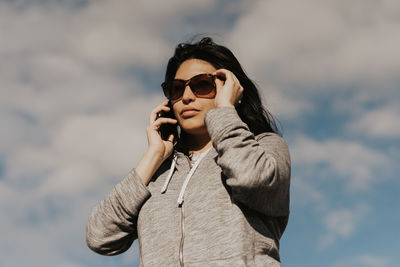 Young woman using mobile phone outdoors