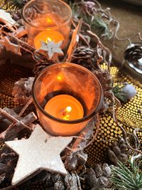 High angle view of lit tea light candles