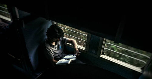 Rear view of man using mobile phone
