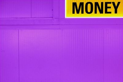 Money text on purple wall