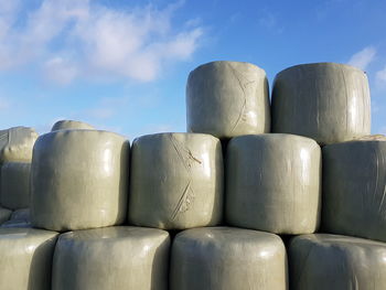 Stack of chairs against blue sky