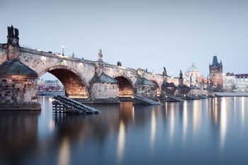 Bridge over river in city against clear sky