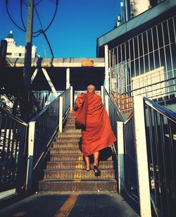 Rear view of a monk walking on street