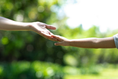 Midsection of woman with arms raised