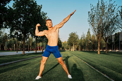 Full length of man exercising on field
