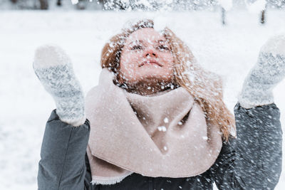 Low angle view of woman with arms raised