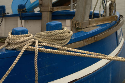 Sailboats moored at harbor