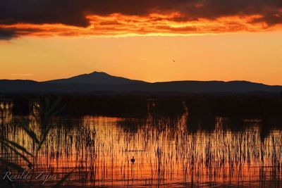 Scenic view of lake during sunset