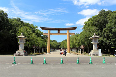 Built structure by trees against sky