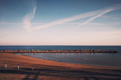 Scenic view of beach against sky during sunset