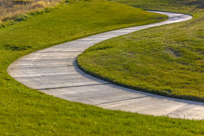 High angle view of winding road on field