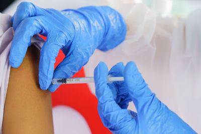 Cropped hand of doctor examining patient in hospital