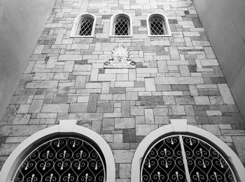 High angle view of manhole on tiled wall of building