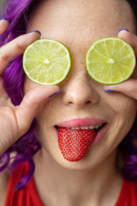 Close-up of woman with fruits