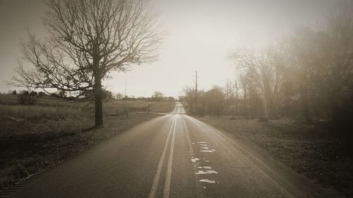 Road amidst trees against sky