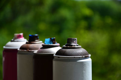 Close-up of spray bottles in row outdoors