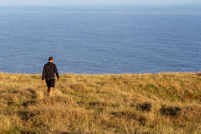 Rear view of man looking at sea